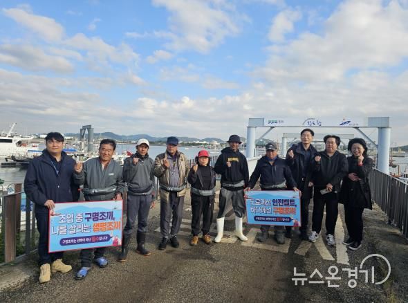 안산시와 경기도, 수협 등 관계기관 관계자들이 구명조끼 착용 홍보를 진행하고 기념촬영을 하고 있다